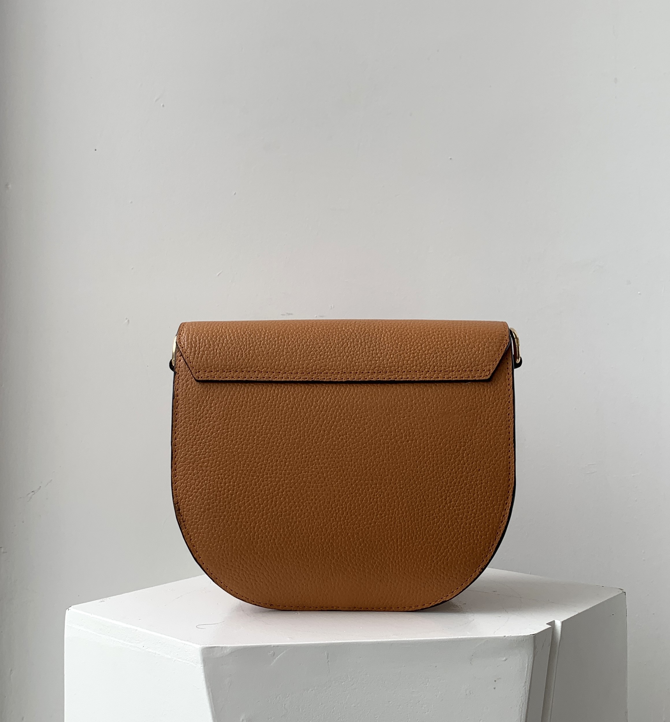 Curved cross body flap bag back side